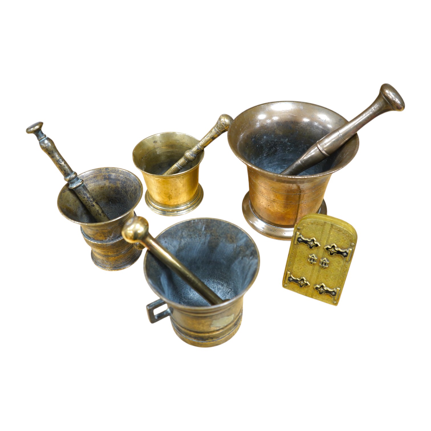 Four various bronze pestles and mortars and a small enamelled brass photograph frame, largest mortar 13cm high. Condition - fair